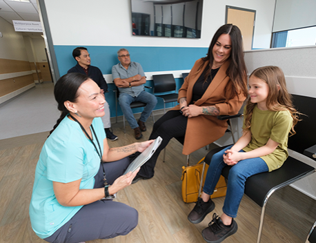 a nurse talking with patients in a waiting room