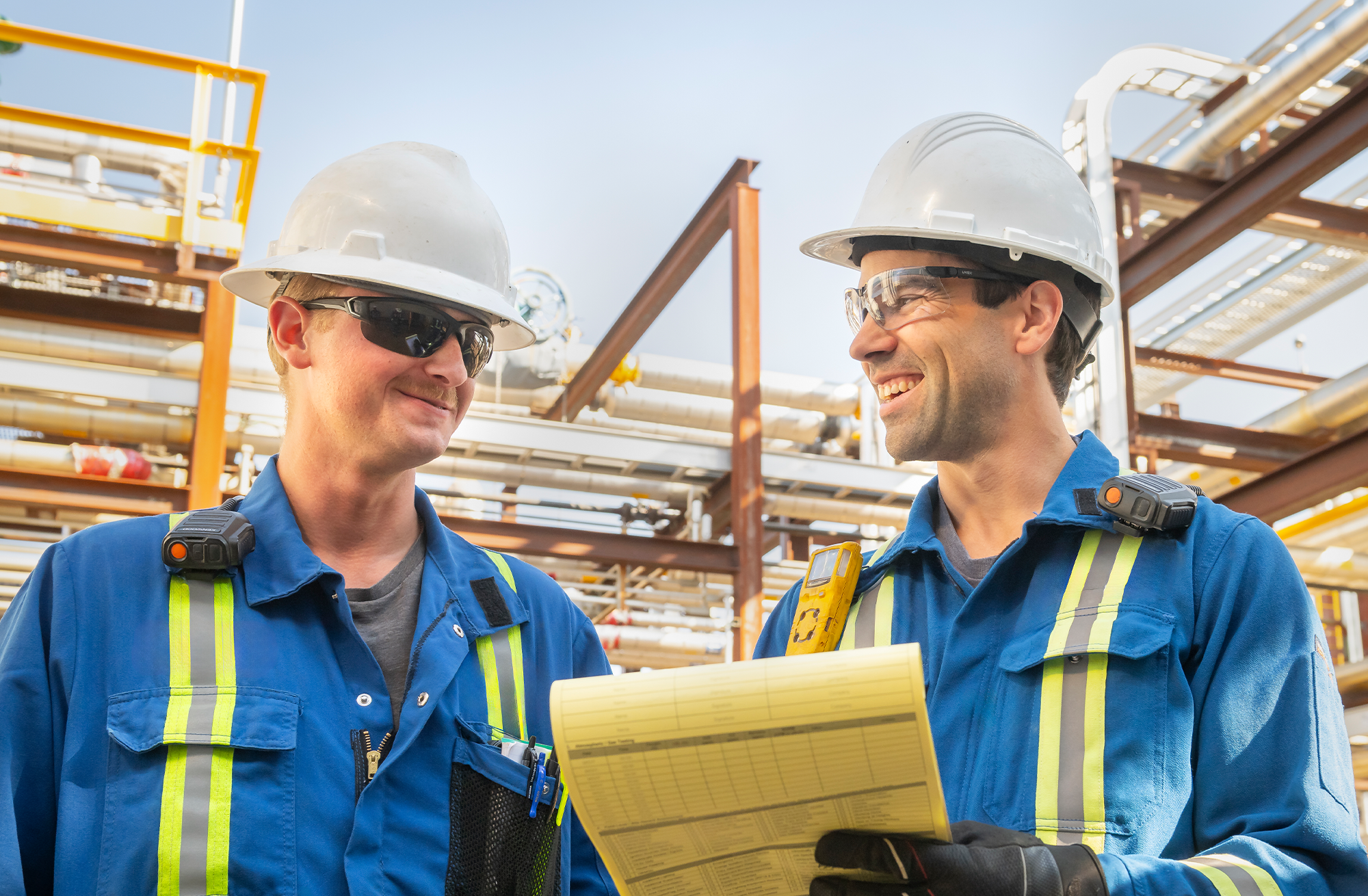 two men in safety gear chatting